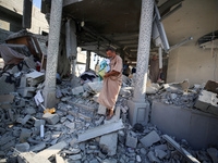 Palestinians are inspecting the rubble following overnight Israeli bombardment which is hitting the Abu Nada family home at the Nuseirat ref...