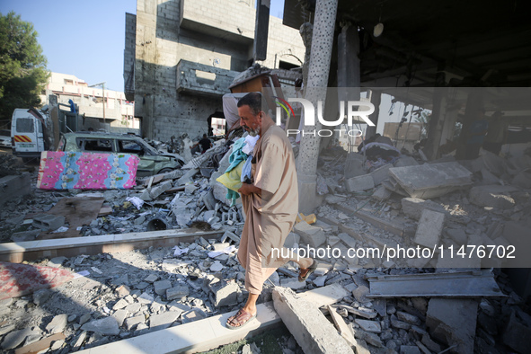 Palestinians are inspecting the rubble following overnight Israeli bombardment which is hitting the Abu Nada family home at the Nuseirat ref...