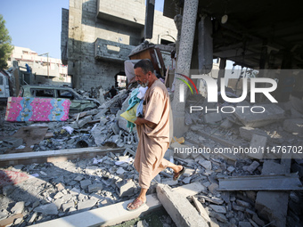 Palestinians are inspecting the rubble following overnight Israeli bombardment which is hitting the Abu Nada family home at the Nuseirat ref...