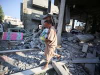 Palestinians are inspecting the rubble following overnight Israeli bombardment which is hitting the Abu Nada family home at the Nuseirat ref...