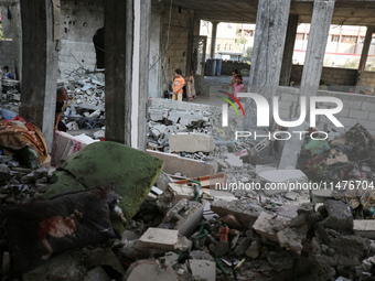 Palestinians are inspecting the rubble following overnight Israeli bombardment which is hitting the Abu Nada family home at the Nuseirat ref...