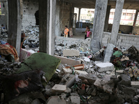 Palestinians are inspecting the rubble following overnight Israeli bombardment which is hitting the Abu Nada family home at the Nuseirat ref...