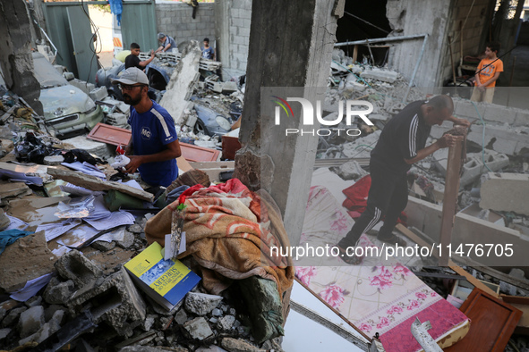 Palestinians are inspecting the rubble following overnight Israeli bombardment which is hitting the Abu Nada family home at the Nuseirat ref...