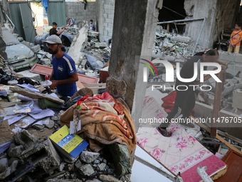 Palestinians are inspecting the rubble following overnight Israeli bombardment which is hitting the Abu Nada family home at the Nuseirat ref...