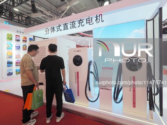 Visitors are visiting the ''Split DC Charger'' at the 2024 Beijing International Charging Pile and Converter Exhibition in Beijing, China, o...