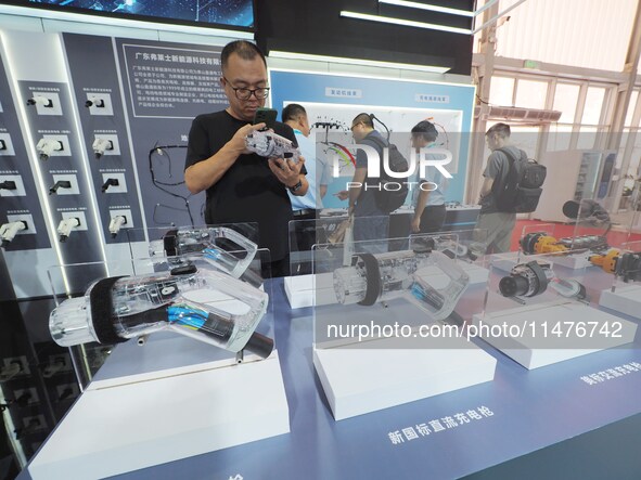 Visitors are viewing a ''charging gun'' at the 2024 Beijing International Charging Pile and Converter Exhibition in Beijing, China, on Augus...