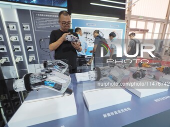 Visitors are viewing a ''charging gun'' at the 2024 Beijing International Charging Pile and Converter Exhibition in Beijing, China, on Augus...