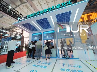 Visitors are visiting the ''Optical Storage, Charge and Discharge Microgrid Overcharge Station'' at the 2024 Beijing International Charging...