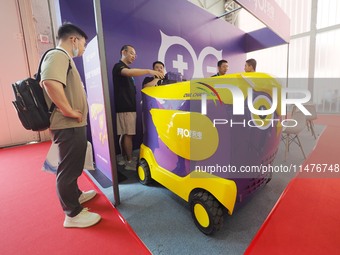 Visitors are visiting a ''mobile charging vehicle'' at the 2024 Beijing International Charging Pile and Power Station Exhibition in Beijing,...