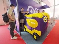 Visitors are visiting a ''mobile charging vehicle'' at the 2024 Beijing International Charging Pile and Power Station Exhibition in Beijing,...