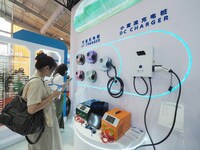 Visitors are visiting a charging pile at the 2024 Beijing International Charging Pile and Converter Exhibition in Beijing, China, on August...