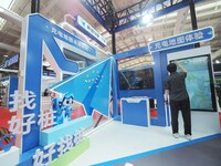 Visitors are experiencing the ''Autonavi Charging Map'' at the 2024 Beijing International Charging Pile and Power Station Exhibition in Beij...