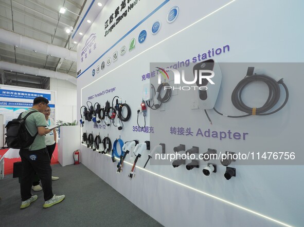 Visitors are viewing a ''charging gun'' at the 2024 Beijing International Charging Pile and Converter Exhibition in Beijing, China, on Augus...