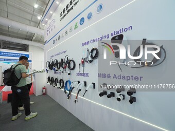 Visitors are viewing a ''charging gun'' at the 2024 Beijing International Charging Pile and Converter Exhibition in Beijing, China, on Augus...