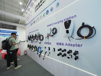 Visitors are viewing a ''charging gun'' at the 2024 Beijing International Charging Pile and Converter Exhibition in Beijing, China, on Augus...