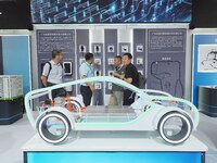 Visitors are viewing a model of a new energy vehicle charging system at the 2024 Beijing International Charging Pile and Power Station Exhib...