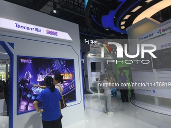 Visitors are visiting the stand of Tencent at the World Artificial Intelligence Conference 2024 in Shanghai, China, on July 4, 2024. On Augu...