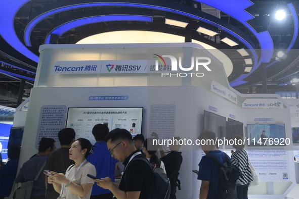 Visitors are visiting the stand of Tencent at the World Artificial Intelligence Conference 2024 in Shanghai, China, on July 4, 2024. On Augu...