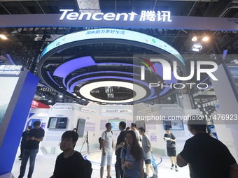 Visitors are visiting the stand of Tencent at the World Artificial Intelligence Conference 2024 in Shanghai, China, on July 4, 2024. On Augu...