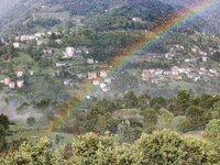 A general view of a rainbow is appearing in the mountains in Bergamo, Italy, on August 13, 2024 (