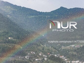 A general view of a rainbow is appearing in the mountains in Bergamo, Italy, on August 13, 2024 (