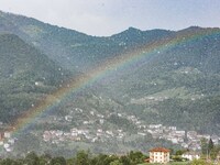 A general view of a rainbow is appearing in the mountains in Bergamo, Italy, on August 13, 2024 (