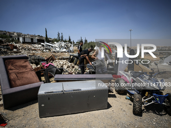 Commercial structures and animal shelters in the area are being demolished as Israeli forces conduct a raid in the At-Tur neighborhood of Ea...