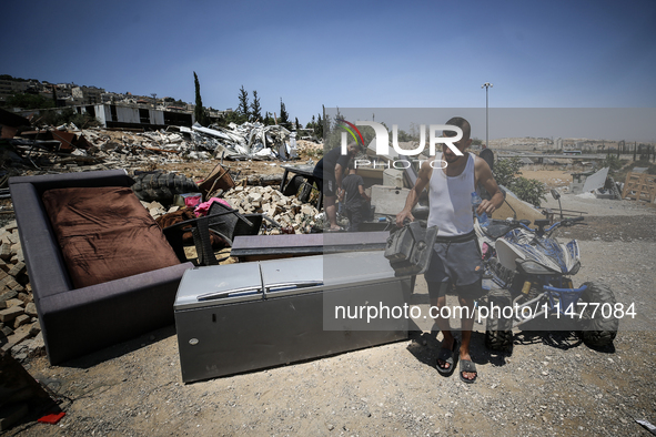 Commercial structures and animal shelters in the area are being demolished as Israeli forces conduct a raid in the At-Tur neighborhood of Ea...