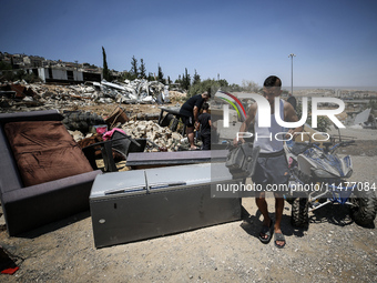 Commercial structures and animal shelters in the area are being demolished as Israeli forces conduct a raid in the At-Tur neighborhood of Ea...