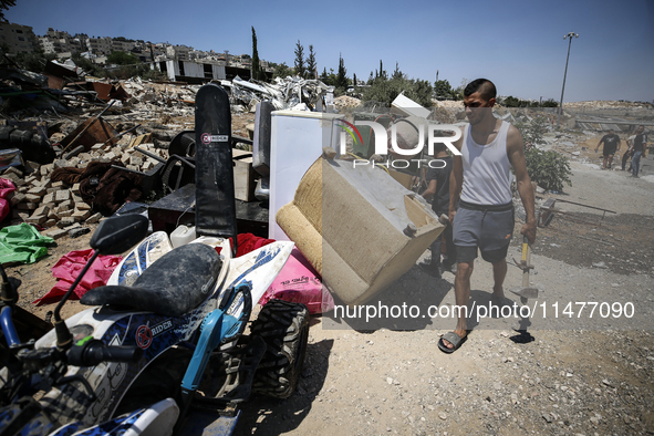 Commercial structures and animal shelters in the area are being demolished as Israeli forces conduct a raid in the At-Tur neighborhood of Ea...