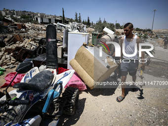 Commercial structures and animal shelters in the area are being demolished as Israeli forces conduct a raid in the At-Tur neighborhood of Ea...