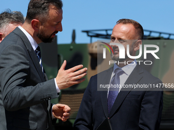 Deputy Prime Minister and Minister of Defence of Poland, Wladyslaw Kosiniak Kamysz speaks to Pawel Matenczuk during a ceremony of signing a...