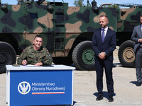 General Artur Kuptel signs a contract as Pawel Matenczuk and Deputy Prime Minister and Minister of Defence of Poland, Wladyslaw Kosiniak Kam...