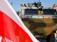 Polish national flags and Light Armored Reconnaissance Carriers KLESZCZ are seen during a ceremony of signing a contract to buy light armour...