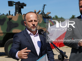 Pawel Matenczuk speaks to media during a ceremony of signing a contract to buy light armour vehicles for the Polish army in 1st Warsaw Armou...