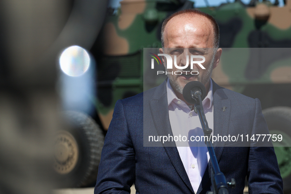 Pawel Matenczuk speaks to media during a ceremony of signing a contract to buy light armour vehicles for the Polish army in 1st Warsaw Armou...