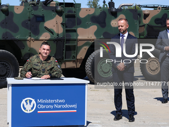 General Artur Kuptel signs a contract as Dariusz Fabisiak CEO of AMZ Kutno and Deputy Prime Minister and Minister of Defence of Poland, Wlad...