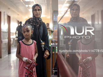 The Palestinian child Sila Houso, 7 years old, is being displaced from Gaza City to the central Gaza Strip. She is being injured during an I...