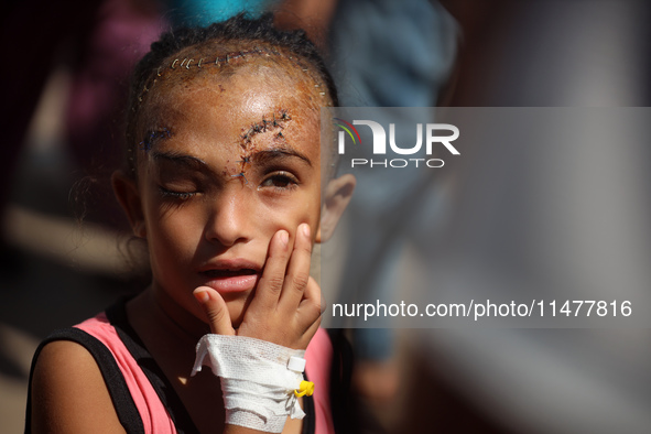 The Palestinian child Sila Houso, 7 years old, is being displaced from Gaza City to the central Gaza Strip. She is being injured during an I...