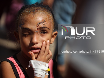 The Palestinian child Sila Houso, 7 years old, is being displaced from Gaza City to the central Gaza Strip. She is being injured during an I...