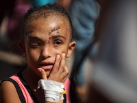 The Palestinian child Sila Houso, 7 years old, is being displaced from Gaza City to the central Gaza Strip. She is being injured during an I...