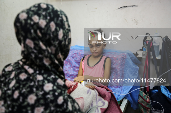 The Palestinian child Sila Houso, 7 years old, is being displaced from Gaza City to the central Gaza Strip. She is being injured during an I...