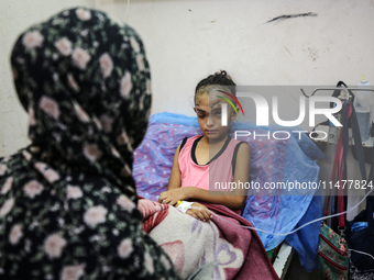 The Palestinian child Sila Houso, 7 years old, is being displaced from Gaza City to the central Gaza Strip. She is being injured during an I...