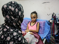 The Palestinian child Sila Houso, 7 years old, is being displaced from Gaza City to the central Gaza Strip. She is being injured during an I...