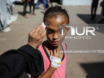 The Palestinian child Sila Houso, 7 years old, is being displaced from Gaza City to the central Gaza Strip. She is being injured during an I...