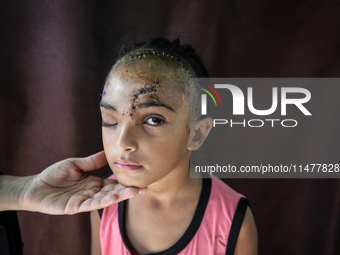 The Palestinian child Sila Houso, 7 years old, is being displaced from Gaza City to the central Gaza Strip. She is being injured during an I...