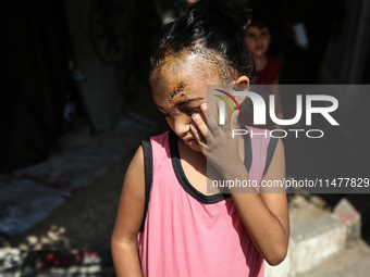 The Palestinian child Sila Houso, 7 years old, is being displaced from Gaza City to the central Gaza Strip. She is being injured during an I...