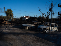 Destroyed cars are sitting in a lumber warehouse in the Vrilissia area, due to the fire that is breaking out in Athens, Greece, on August 11...