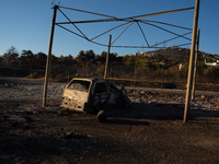 A destroyed car is sitting in a lumber warehouse in the Vrilissia area, due to the fire that broke out in Athens, Greece, on August 11, 2024...