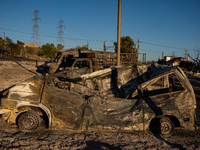 A destroyed car is sitting in a lumber warehouse in the Vrilissia area, due to the fire that broke out in Athens, Greece, on August 11, 2024...